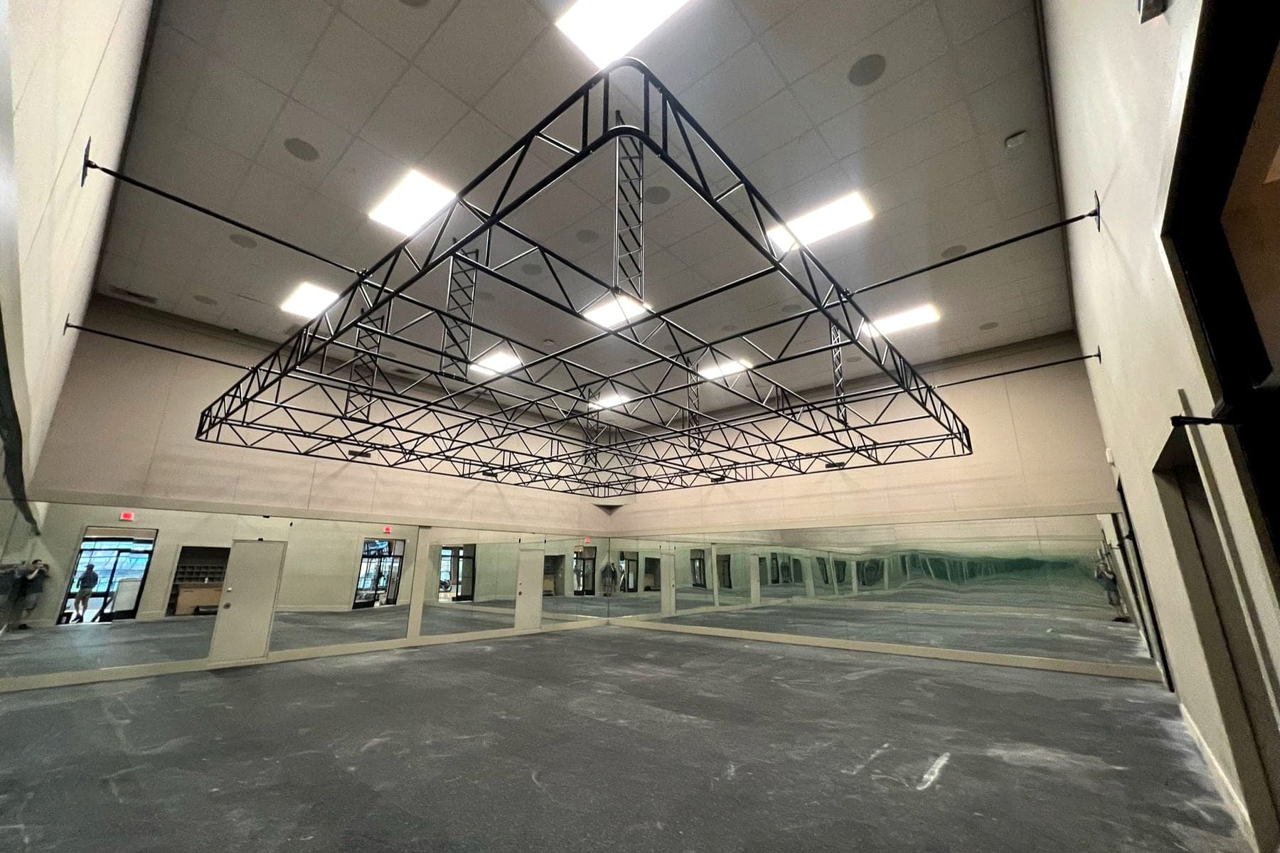 Fabricated steel truss structure suspended from a commercial ceiling