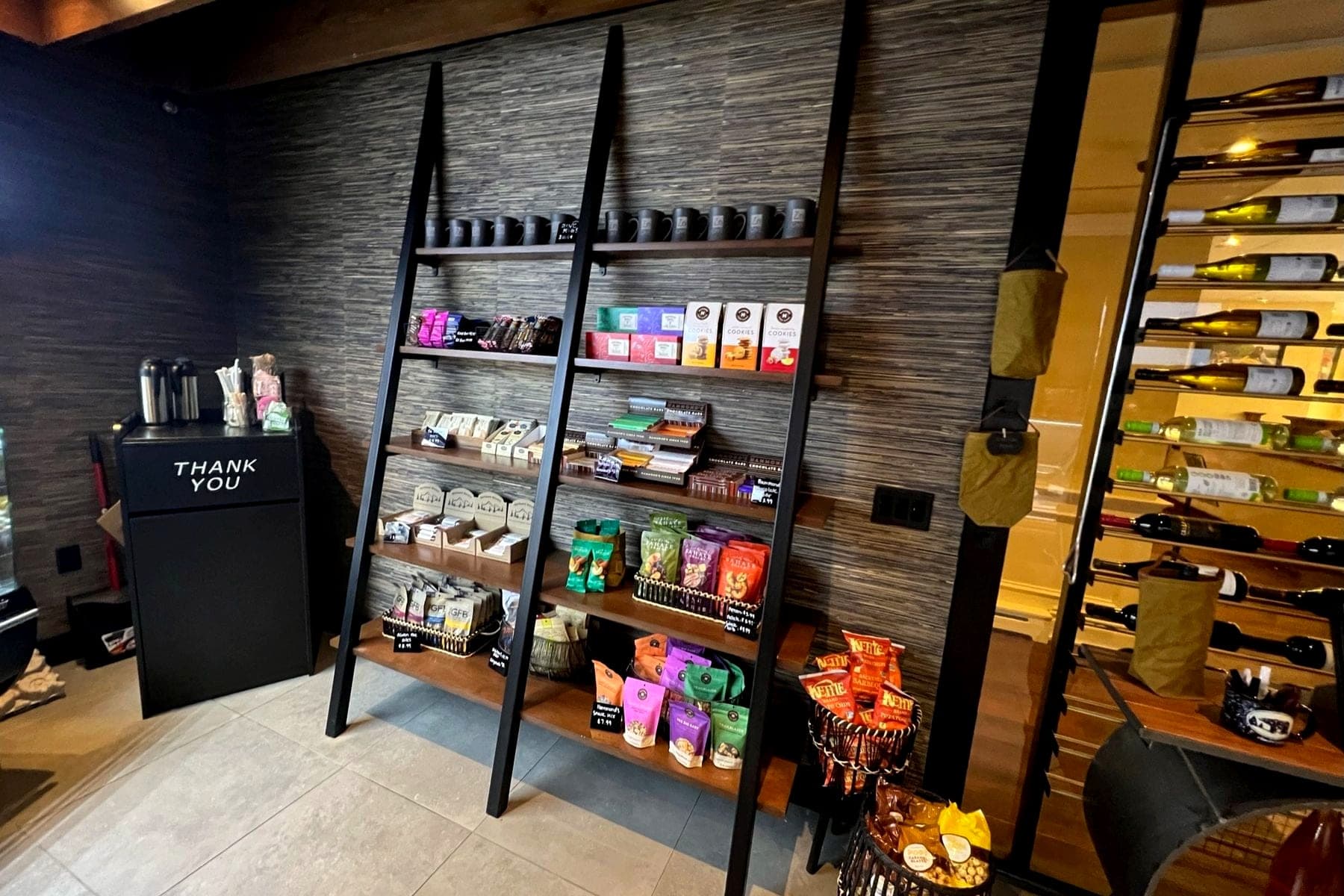 Fabricated steel ladder shelving and wine display in a retail space