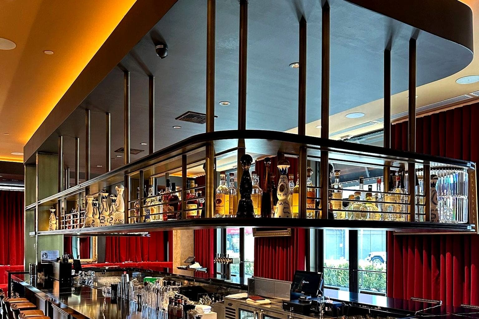 Custom bar with a fabricated steel canopy and bottle display