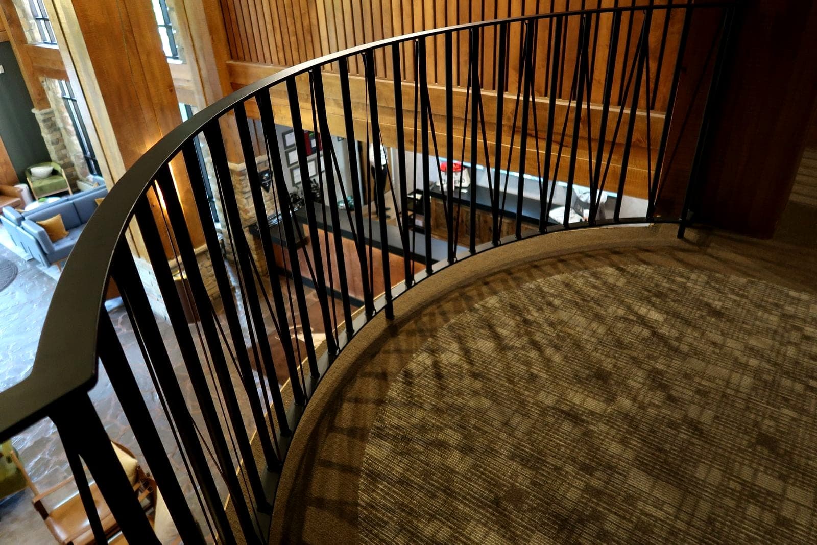 Curved steel railing wrapping a mezzanine