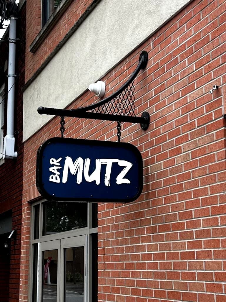Bar Mutz storefront blade sign and bracket