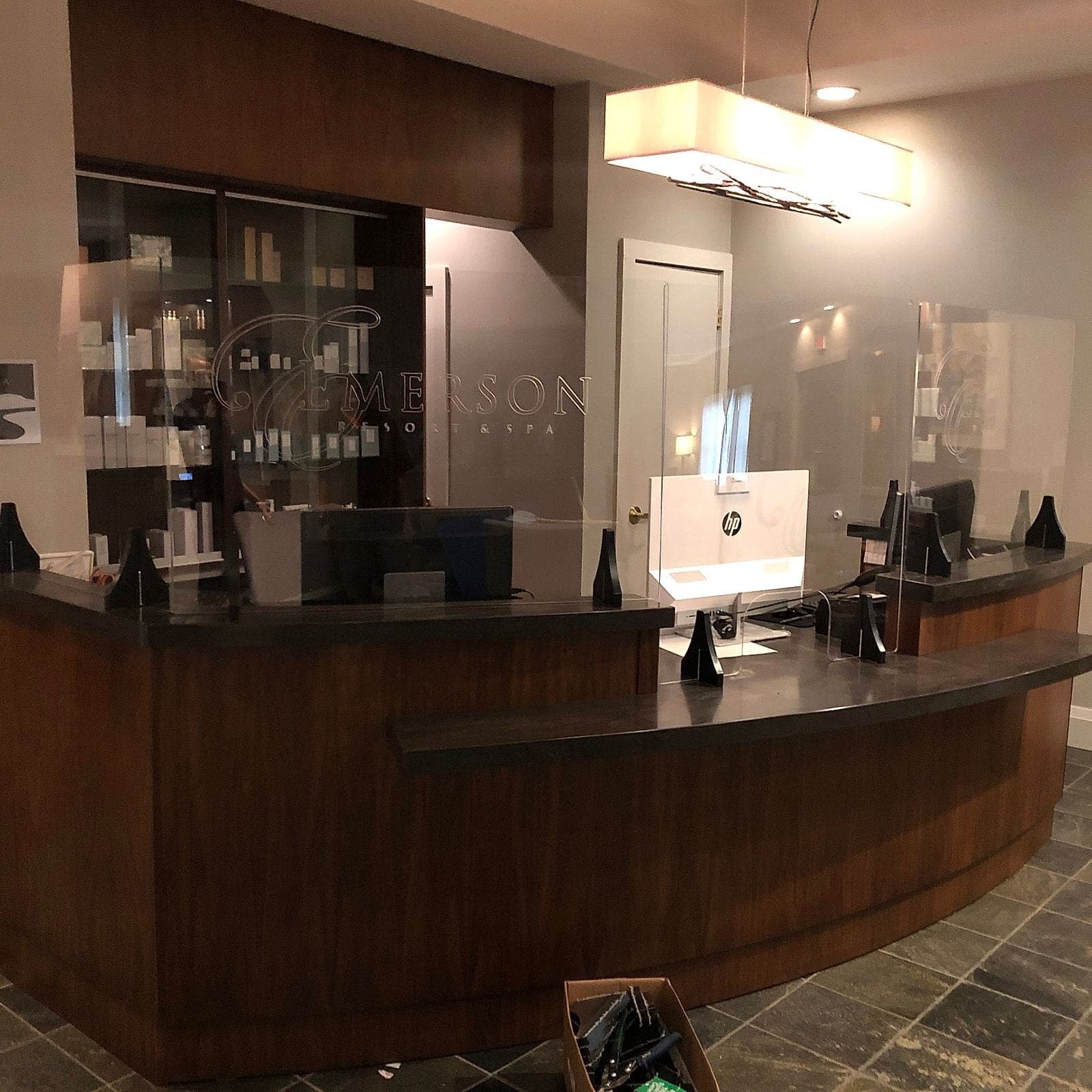 Engraved acrylic screens wrapping a reception counter