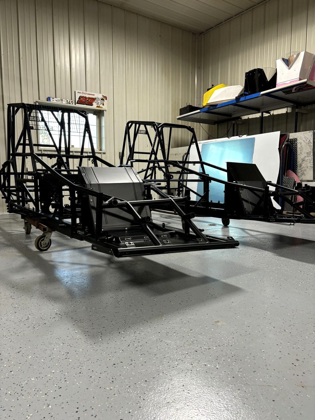 Bare chassis on stands in the Teo Pro Car shop